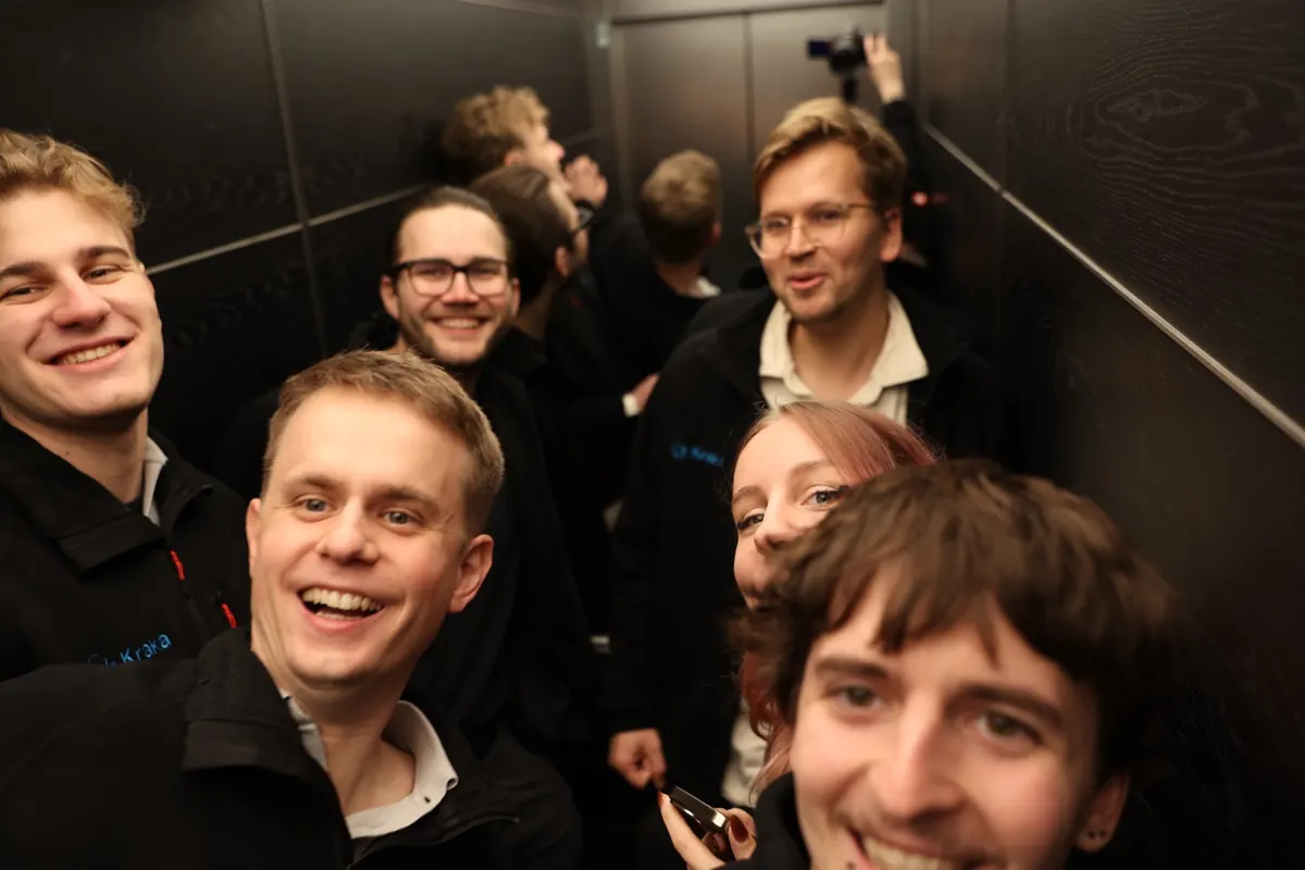 Selfie of the Berlin team squeezed into a lift, everyone laughing